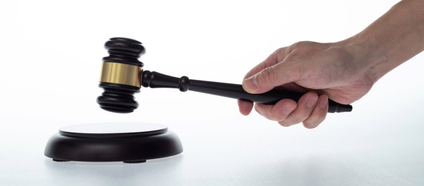 human-hand-holding-wooden-gavel